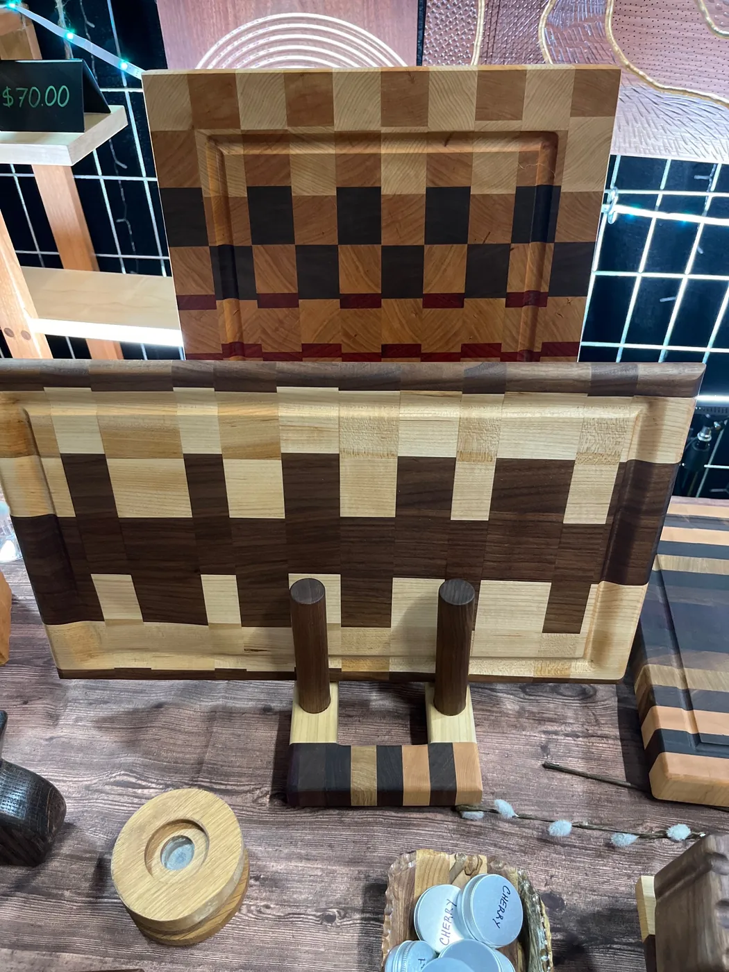 Handmade cutting boards displayed upright on a wooden stand