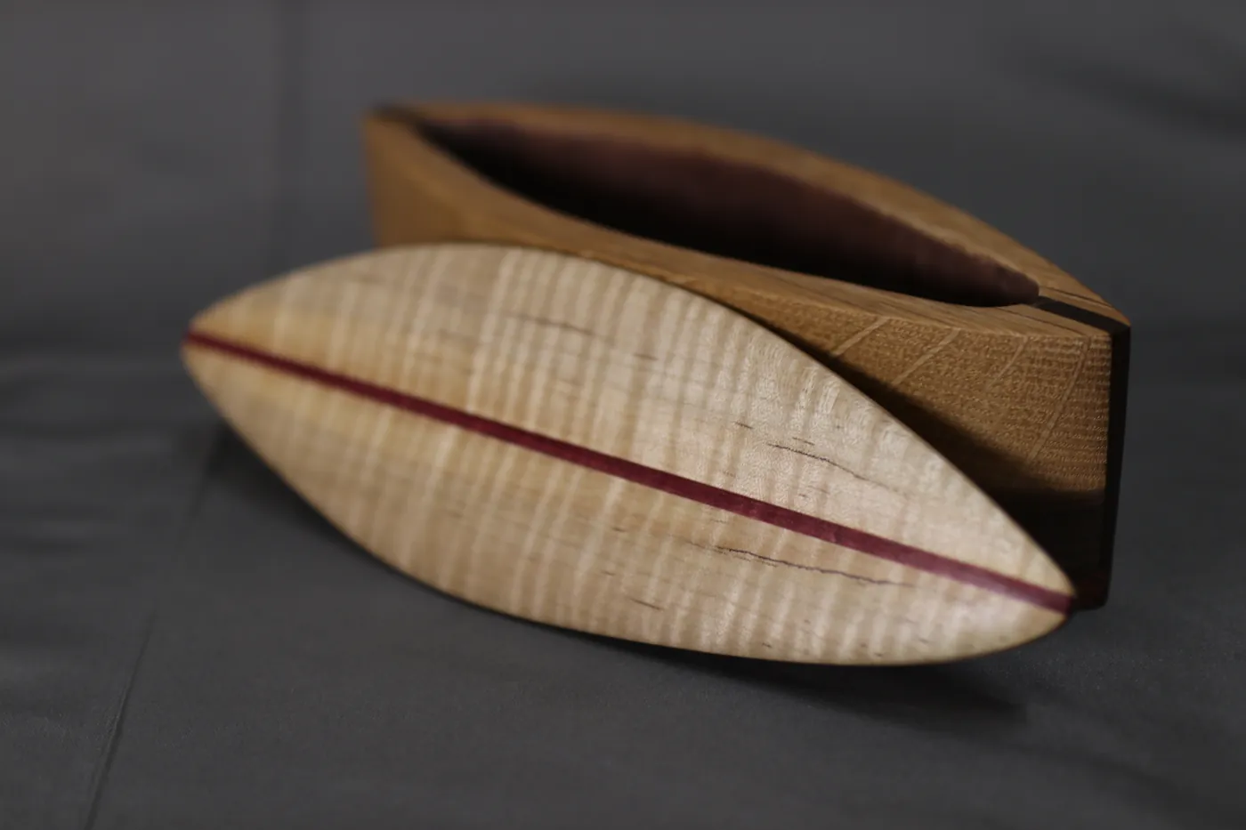 Curved handmade wooden box with maple grain and purpleheart accent