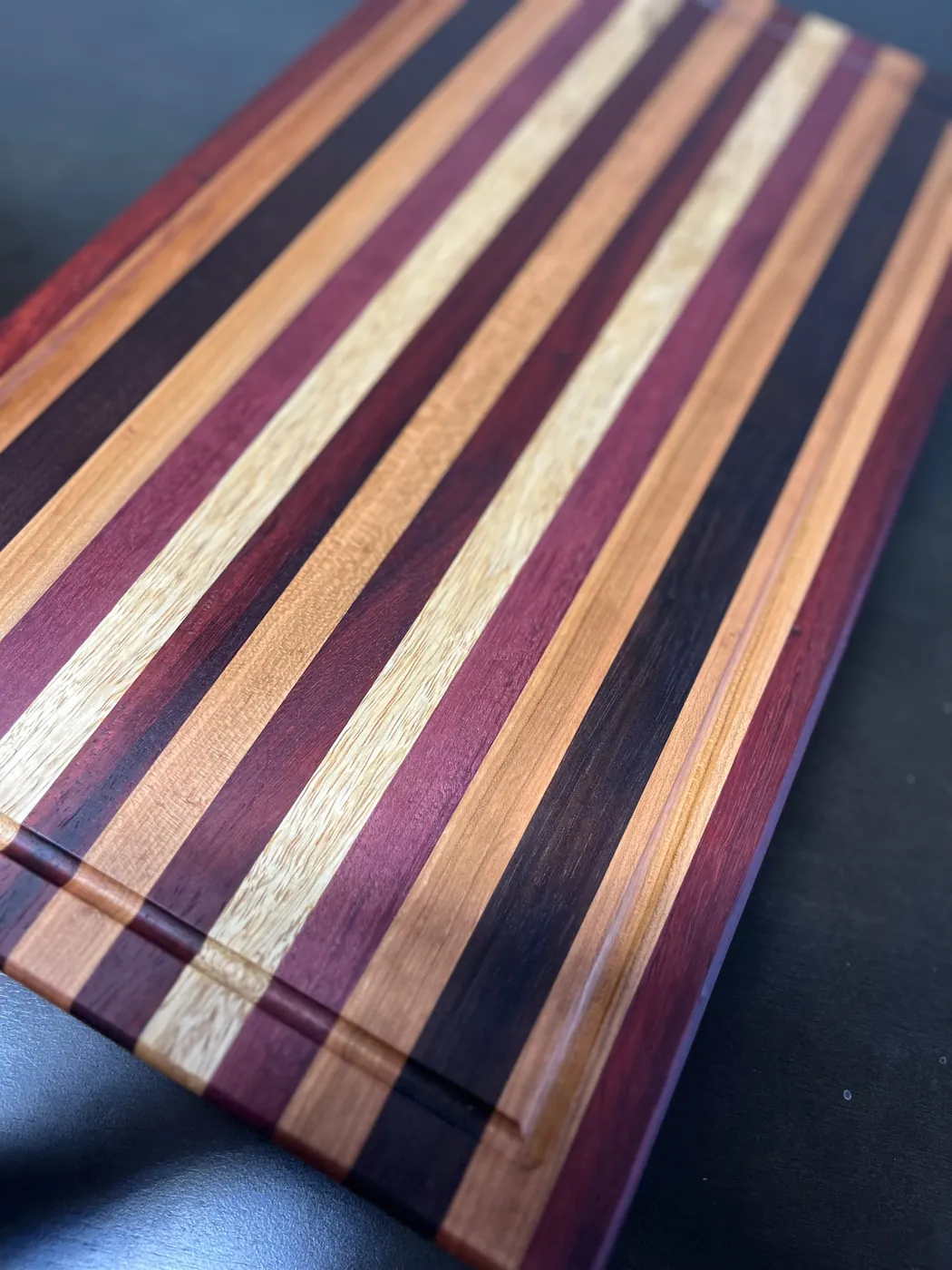 Close-up of mixed hardwood stripes on a handmade board