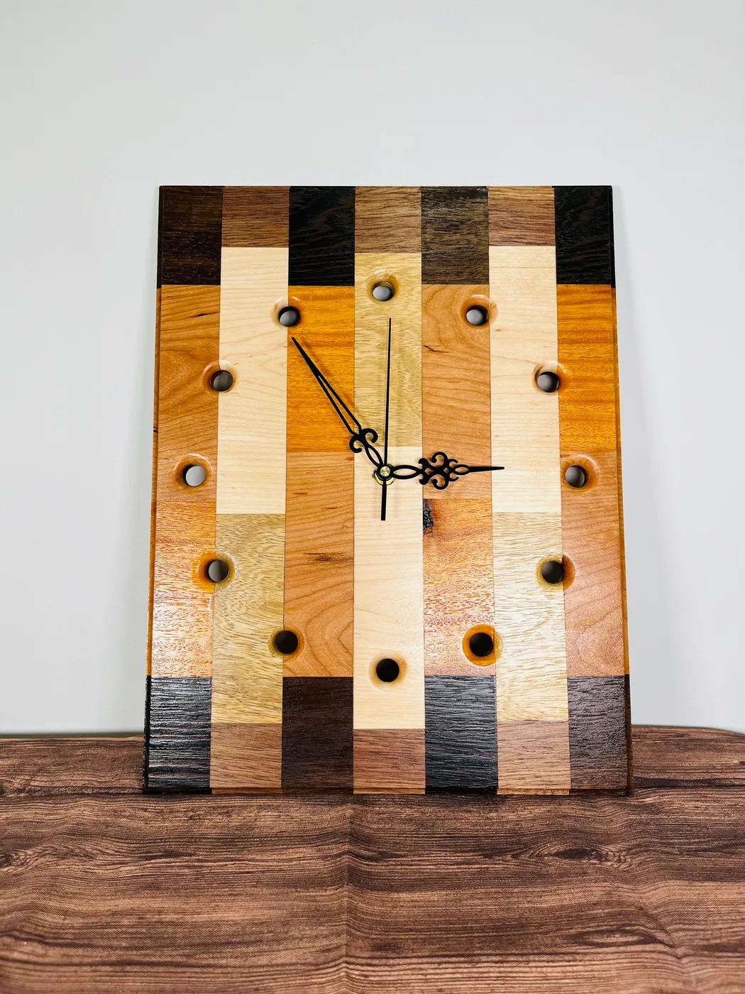 Rectangular handmade wood wall clock with mixed hardwood strips and black hands