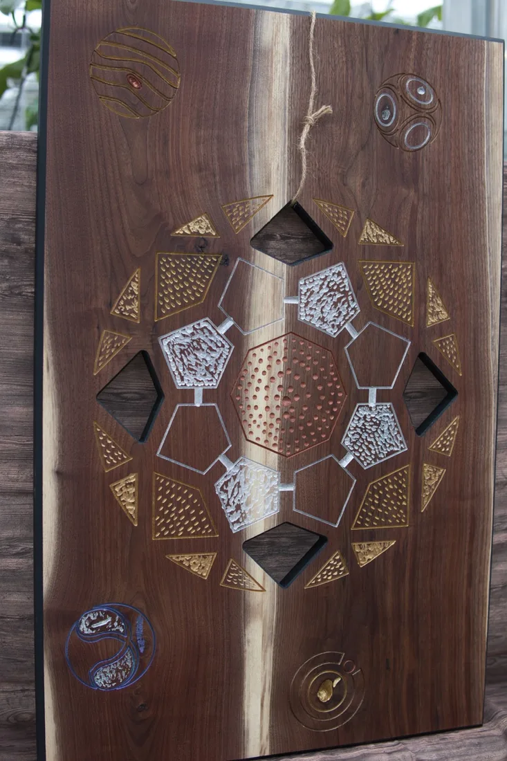 Round handmade wooden clock with a dark center and light wood ring