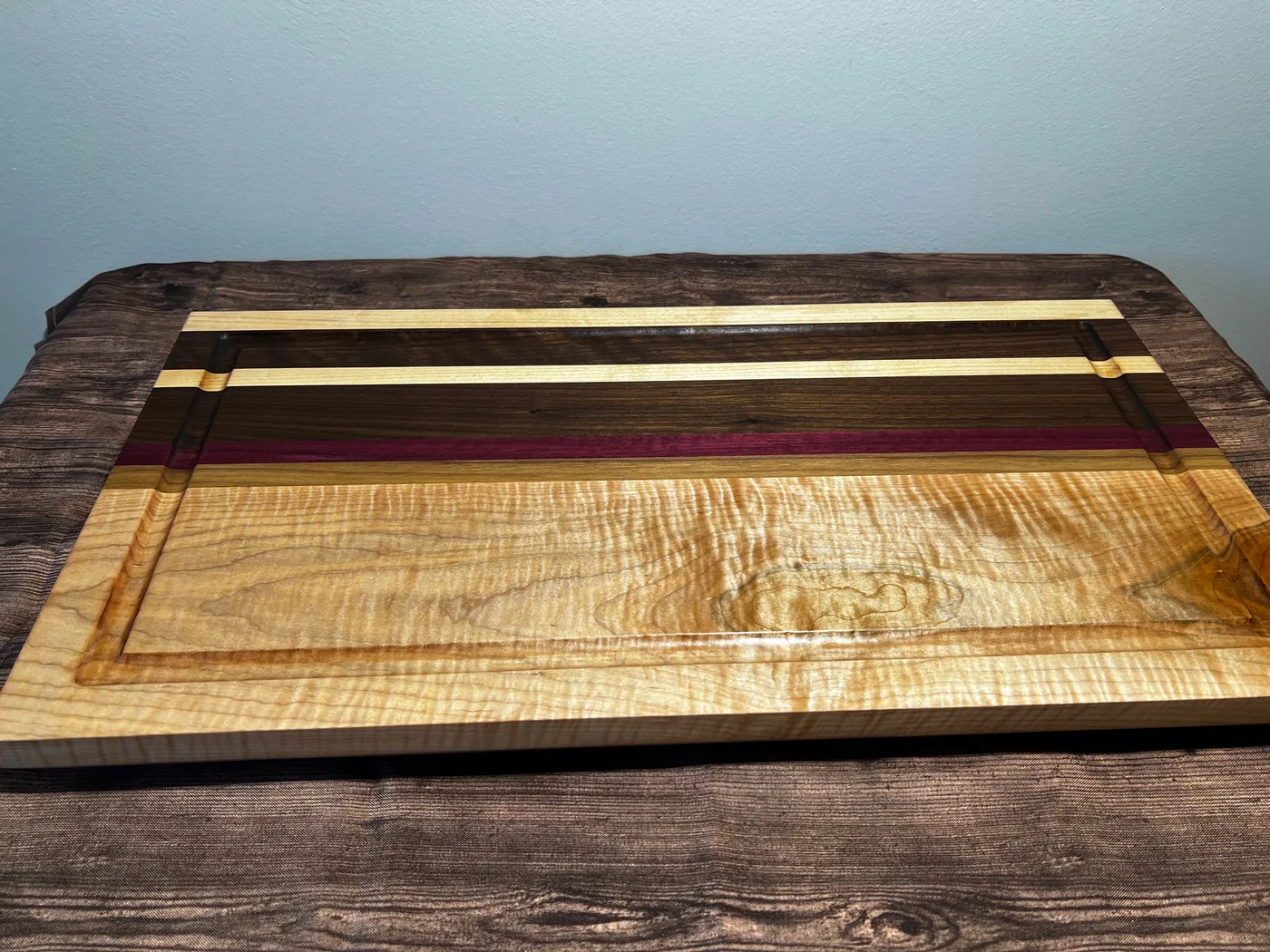 End-grain cutting board with walnut, maple, and warm hardwood strips