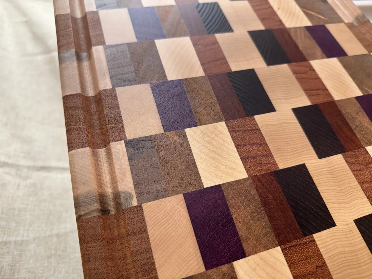 End-grain cutting board with tight mixed hardwood block pattern