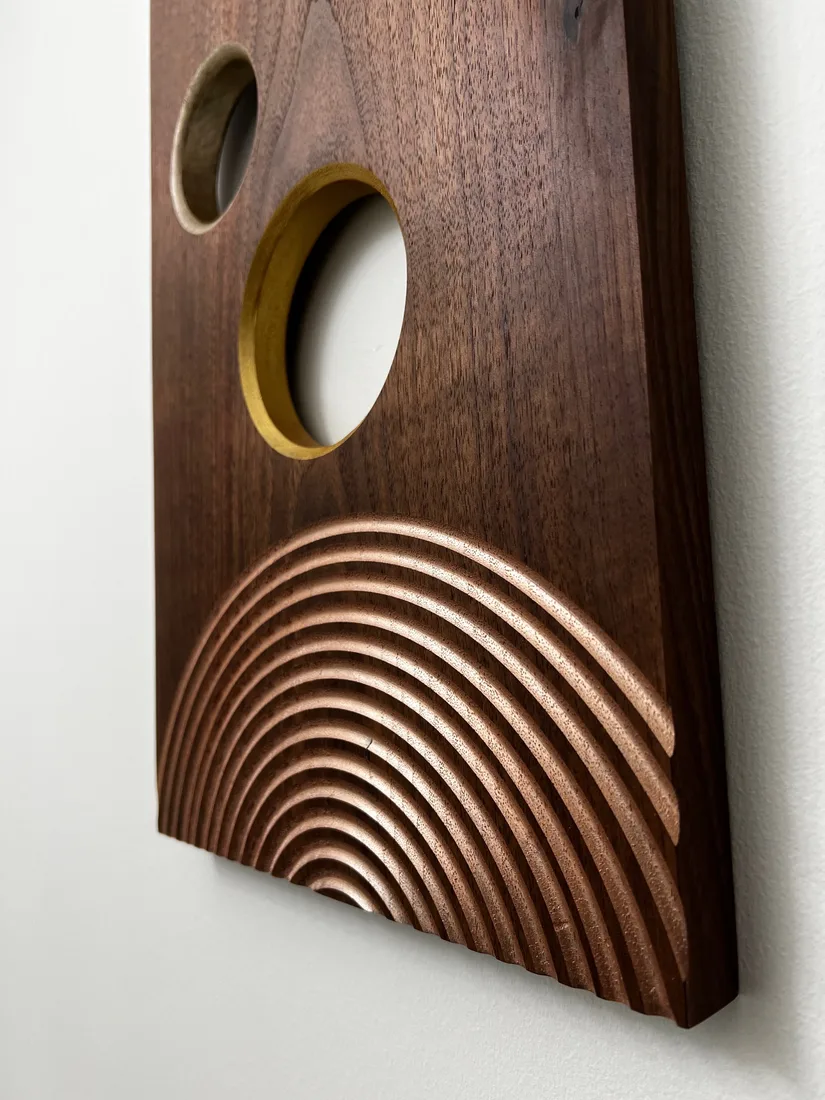 Round wooden wall art with an inset galaxy style scene